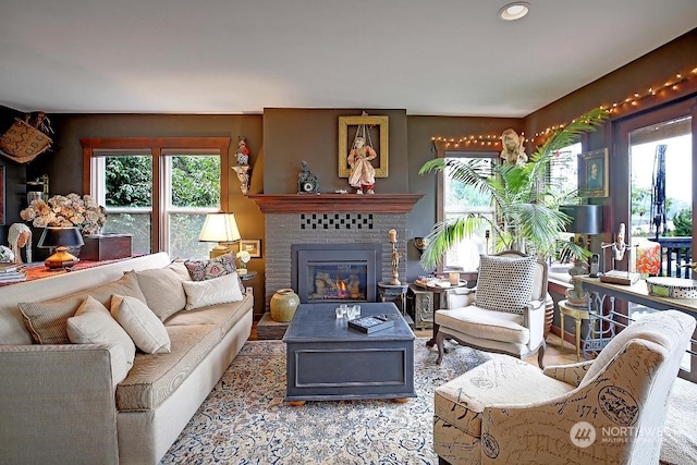 living room featuring a brick fireplace