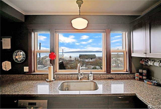 kitchen featuring light stone countertops and sink