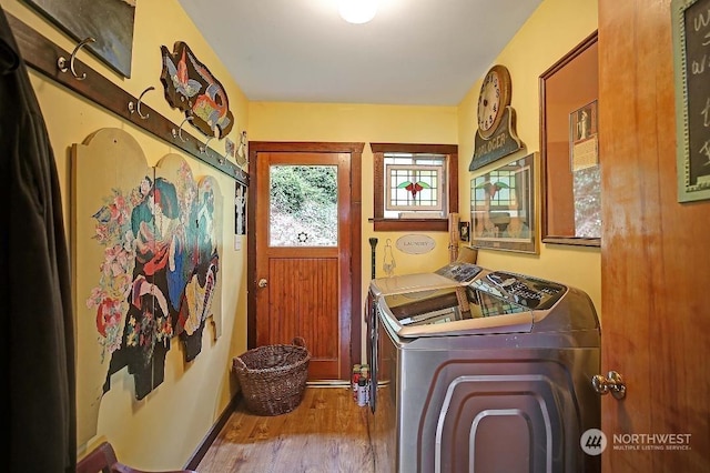 laundry area featuring hardwood / wood-style flooring and separate washer and dryer