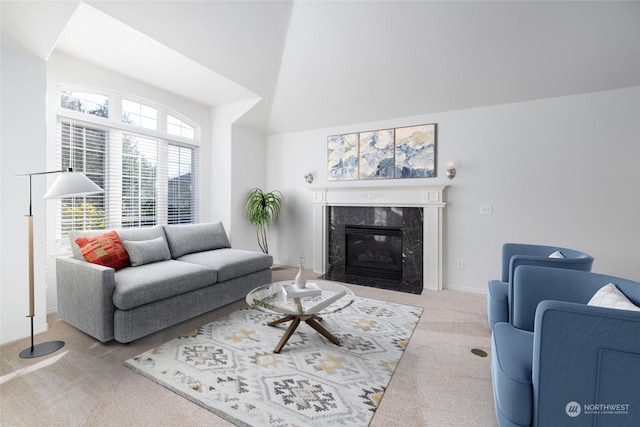 carpeted living room with a premium fireplace