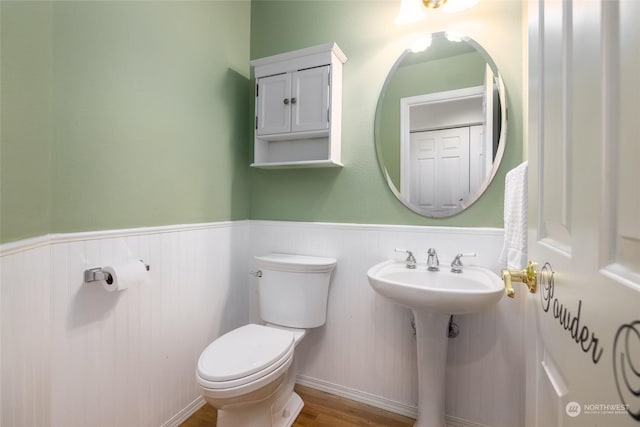 bathroom with toilet and hardwood / wood-style floors