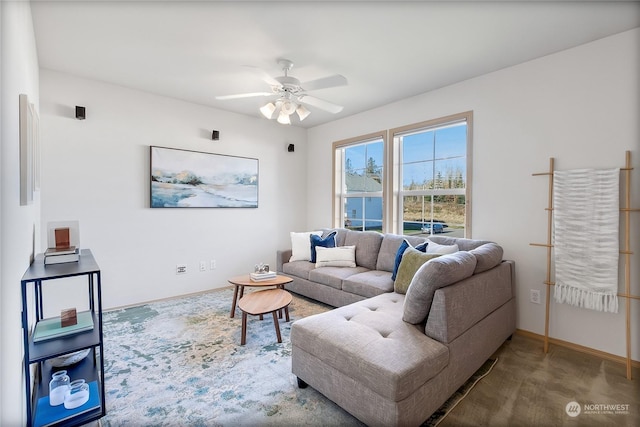 living area with carpet, ceiling fan, and baseboards