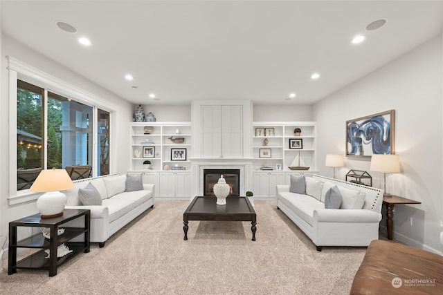 carpeted living room with a high end fireplace