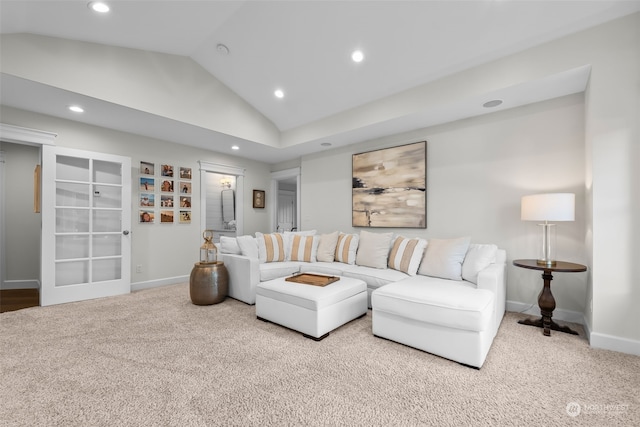 carpeted living room featuring lofted ceiling