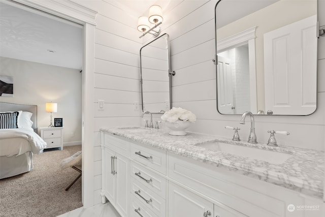 bathroom with vanity and wooden walls