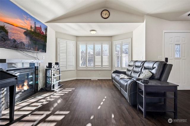 living room featuring dark hardwood / wood-style flooring and lofted ceiling