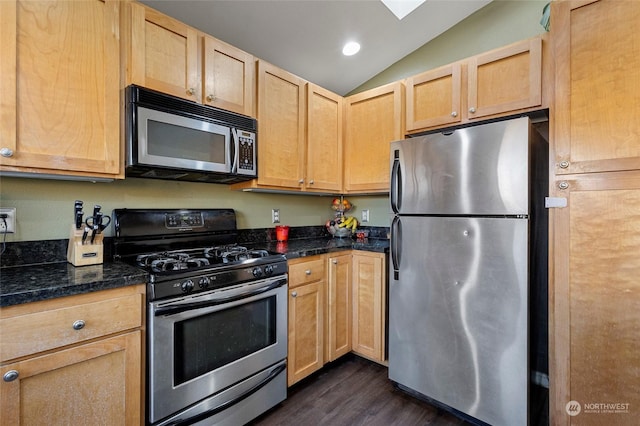 kitchen with dark wood-type flooring, appliances with stainless steel finishes, vaulted ceiling, and light brown cabinets