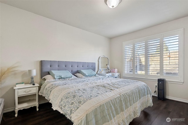 bedroom with dark wood-type flooring