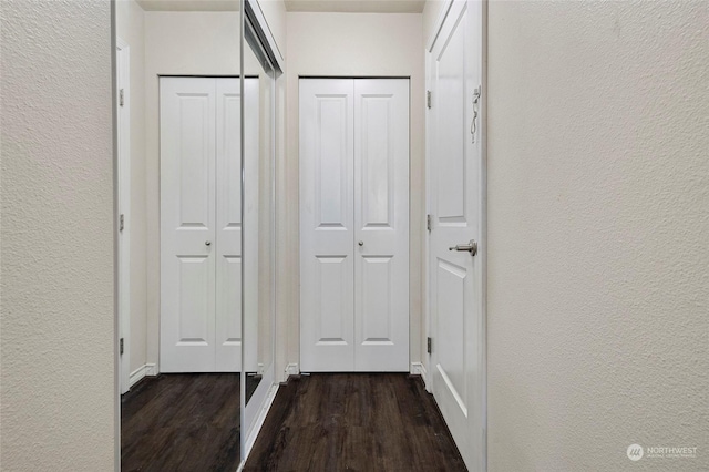 corridor featuring dark wood-type flooring