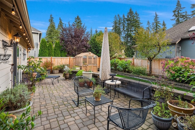 view of patio / terrace with an outdoor living space and an outbuilding