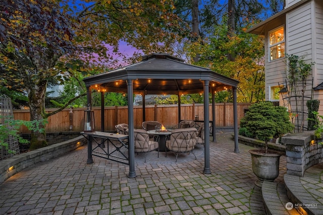 patio terrace at dusk with a gazebo and a fire pit