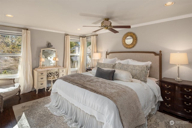 bedroom with dark hardwood / wood-style flooring, crown molding, and ceiling fan