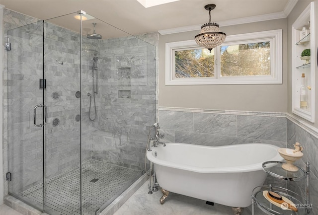 bathroom with crown molding, separate shower and tub, and tile walls