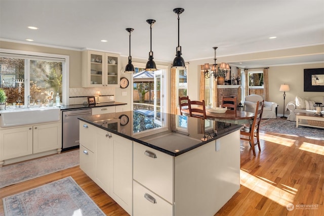 kitchen with white cabinetry, sink, dishwasher, and light wood-type flooring