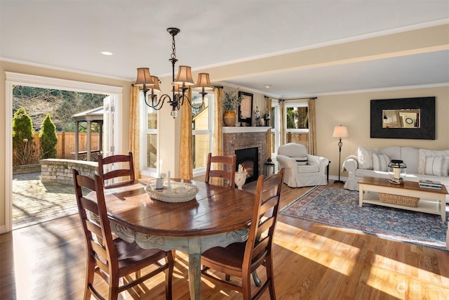 dining room featuring crown molding, a notable chandelier, and hardwood / wood-style flooring