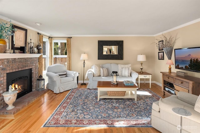 living room featuring crown molding, a fireplace, and hardwood / wood-style floors