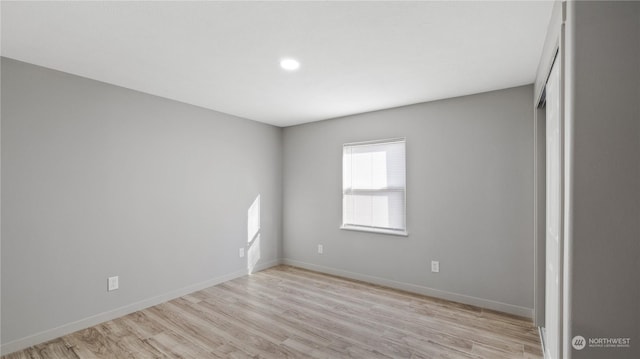 spare room with light hardwood / wood-style flooring