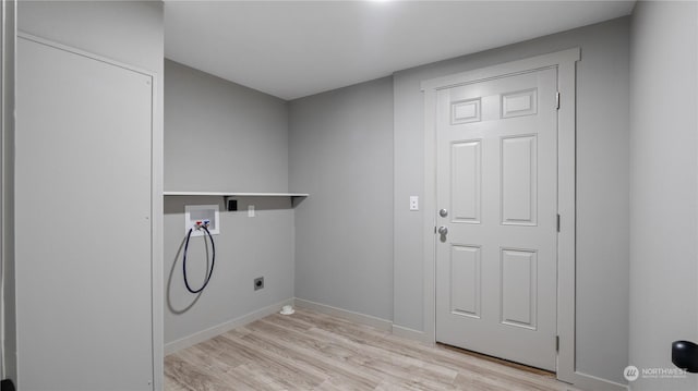 laundry area with washer hookup and light hardwood / wood-style flooring