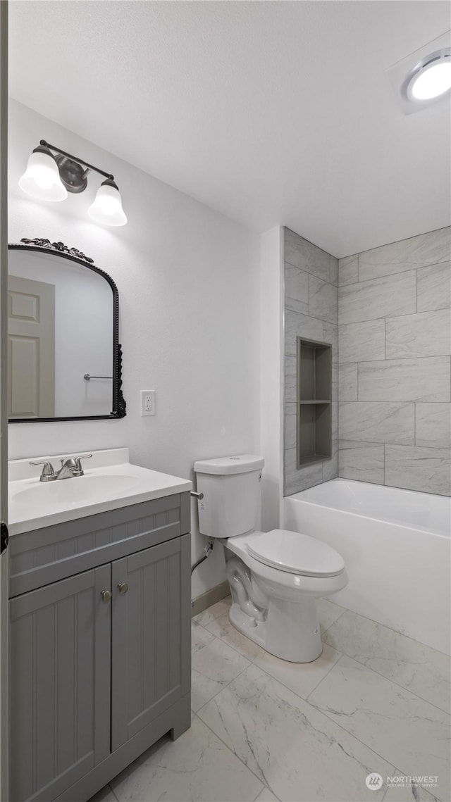 full bathroom with tiled shower / bath combo, vanity, a textured ceiling, and toilet