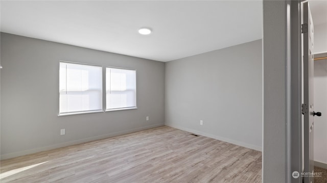 empty room with light hardwood / wood-style flooring