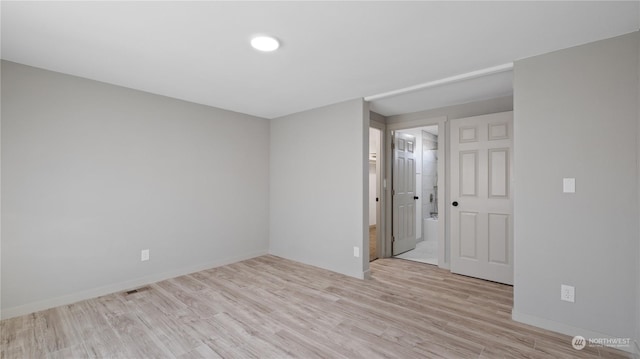 unfurnished room with light wood-type flooring