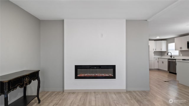 living room with sink and light hardwood / wood-style flooring