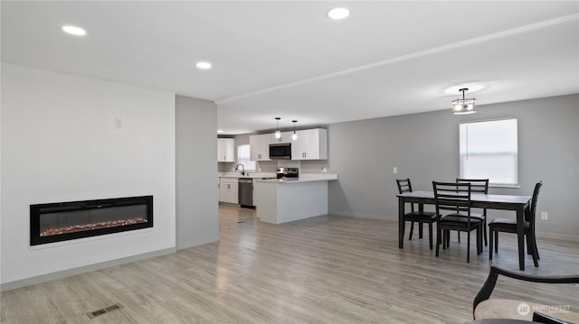 interior space featuring sink and light wood-type flooring