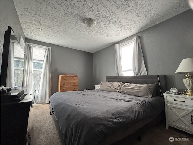 bedroom featuring a textured ceiling and carpet