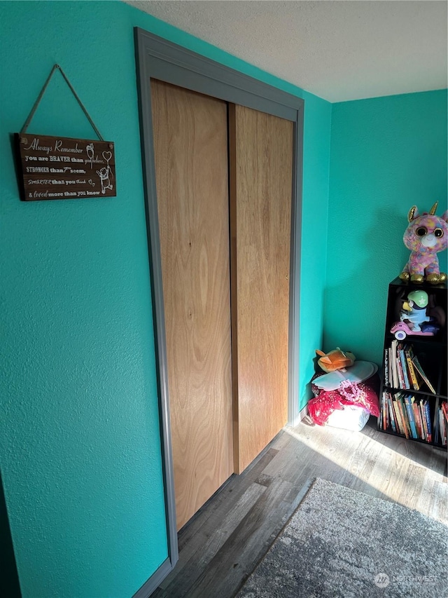 bedroom featuring a closet and wood finished floors