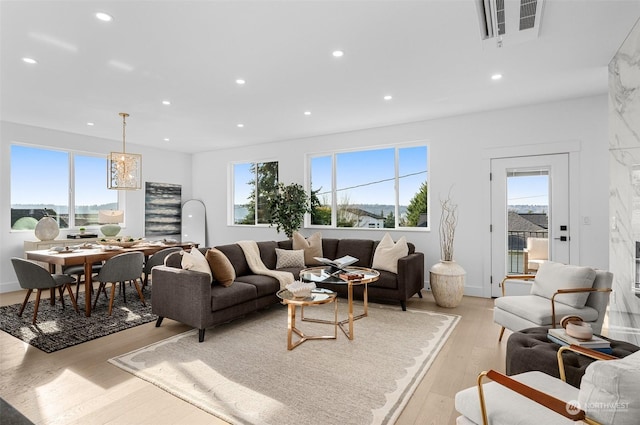 living room featuring plenty of natural light and light hardwood / wood-style flooring