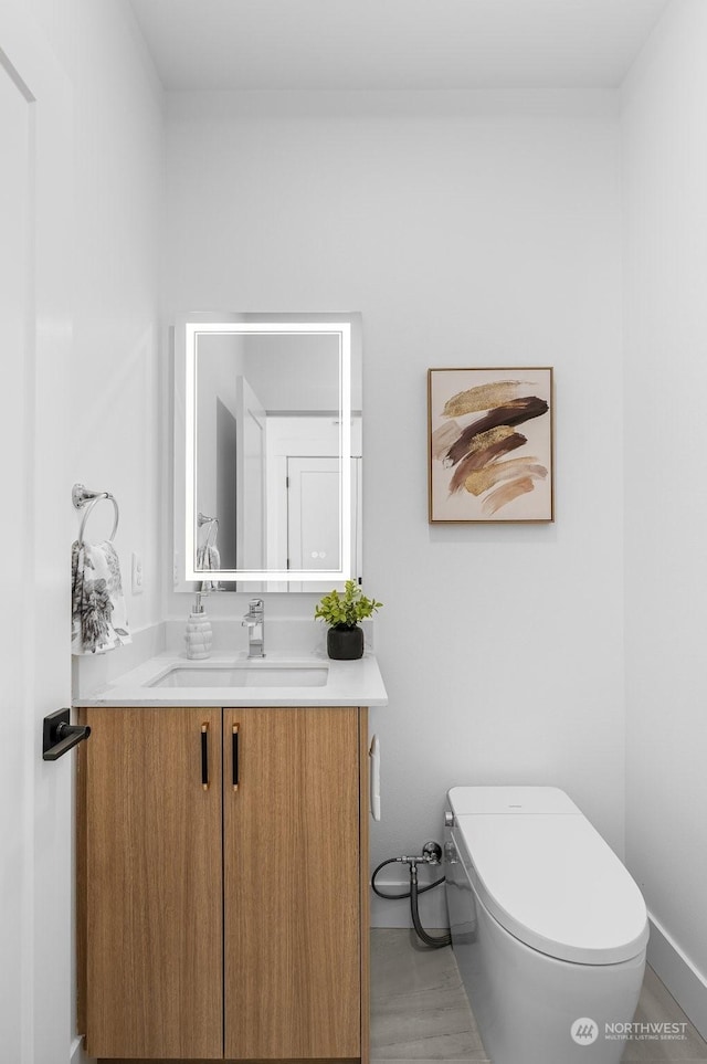 bathroom featuring vanity and toilet