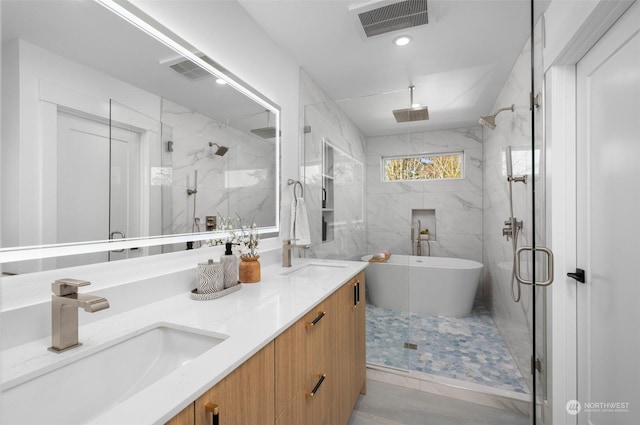 bathroom with vanity and shower with separate bathtub