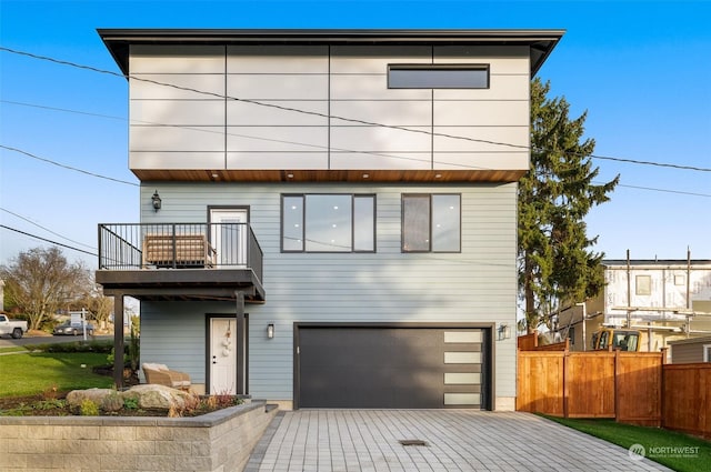 view of front of house featuring a balcony and a garage