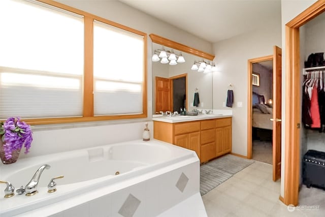 bathroom with tiled tub and vanity