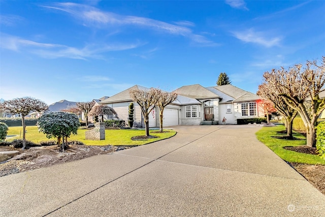 ranch-style house with a garage and a front lawn