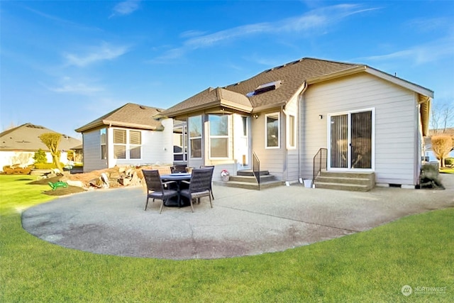 back of house with a lawn and a patio