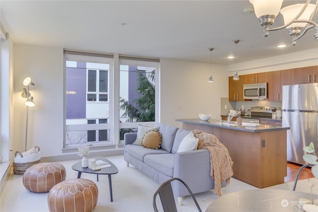 living room with sink and a notable chandelier