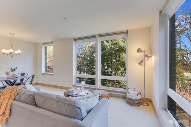 carpeted living room with a notable chandelier