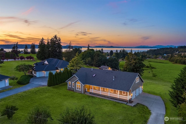 aerial view at dusk with a water view