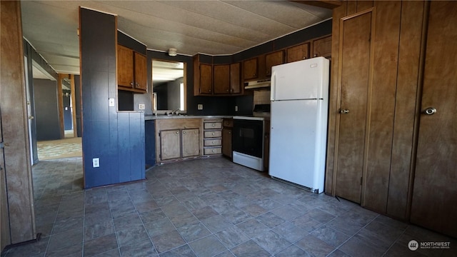 kitchen featuring sink, range with electric stovetop, and white refrigerator