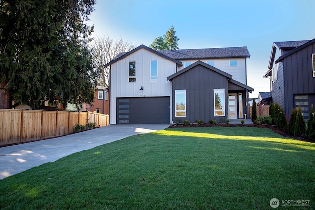 modern farmhouse featuring a garage, fence, concrete driveway, a front lawn, and board and batten siding