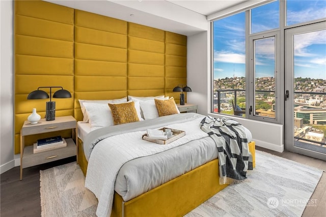 bedroom featuring hardwood / wood-style floors and access to outside