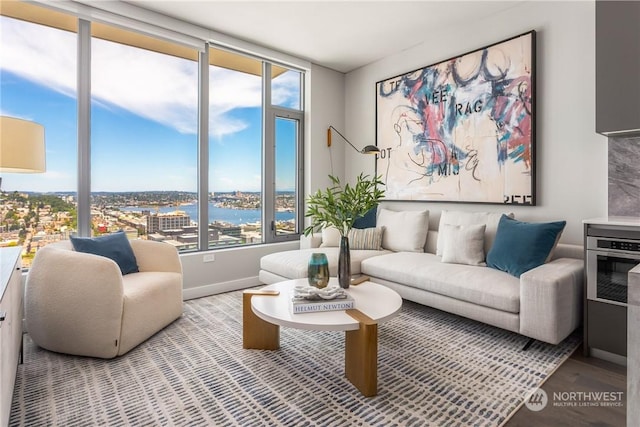 living room with wood-type flooring and a water view