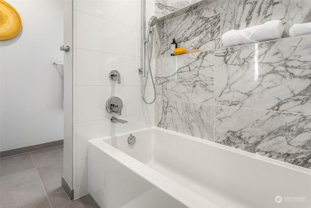 bathroom with tile patterned flooring and tiled shower / bath