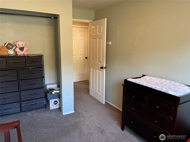 bedroom with carpet floors and baseboards