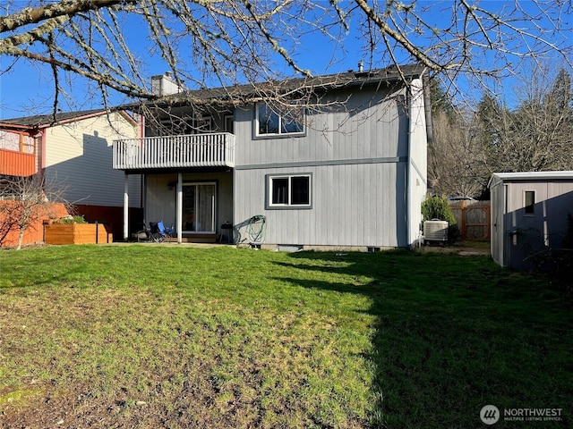 back of house with a balcony, a chimney, fence, cooling unit, and a yard