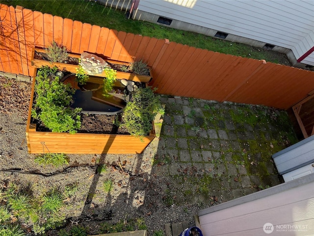 view of yard featuring a vegetable garden and fence