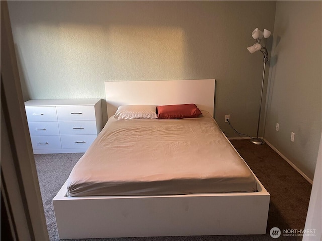 bedroom featuring dark colored carpet