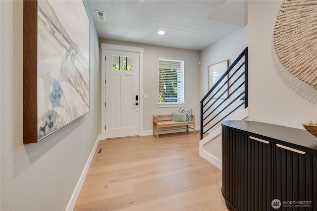 entryway with stairway, visible vents, baseboards, recessed lighting, and light wood-type flooring