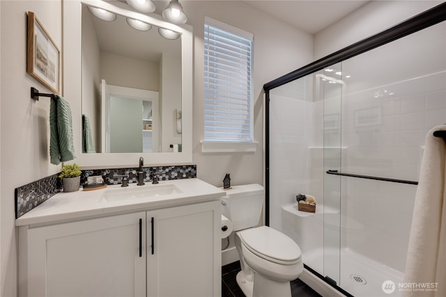 full bath with vanity, toilet, and a shower stall